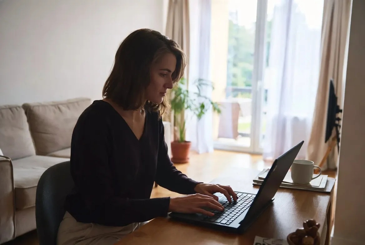 Airbnb host using laptop to manage IPTV subscription for vacation rental