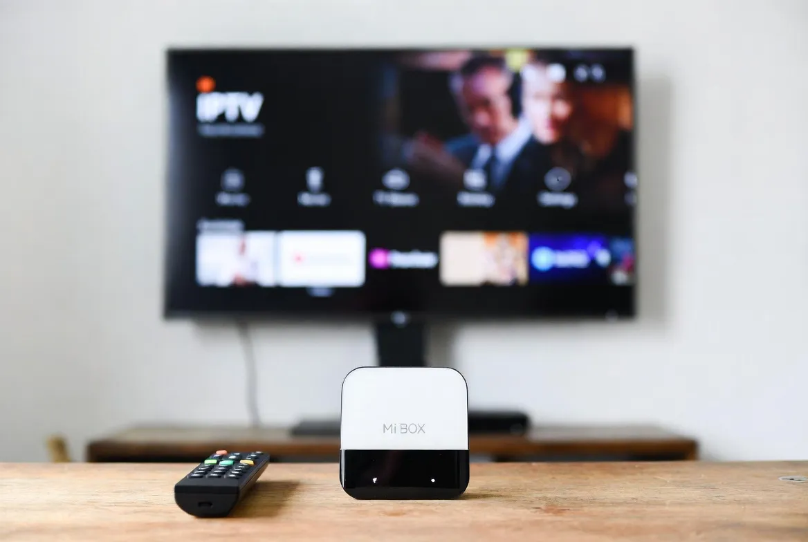 Xiaomi Mi Box on a TV stand streaming IPTV in 4K