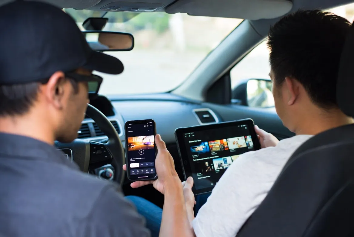 Uber and Lyft drivers streaming IPTV on phone and tablet during downtime